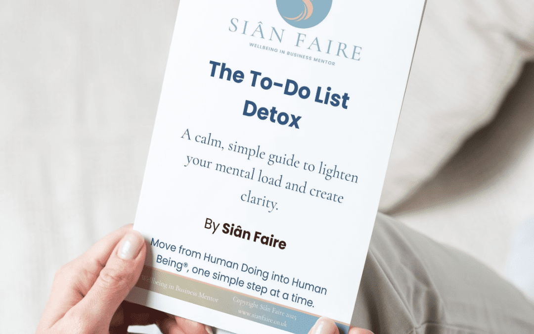 person holding a printout of the to-do detox guide